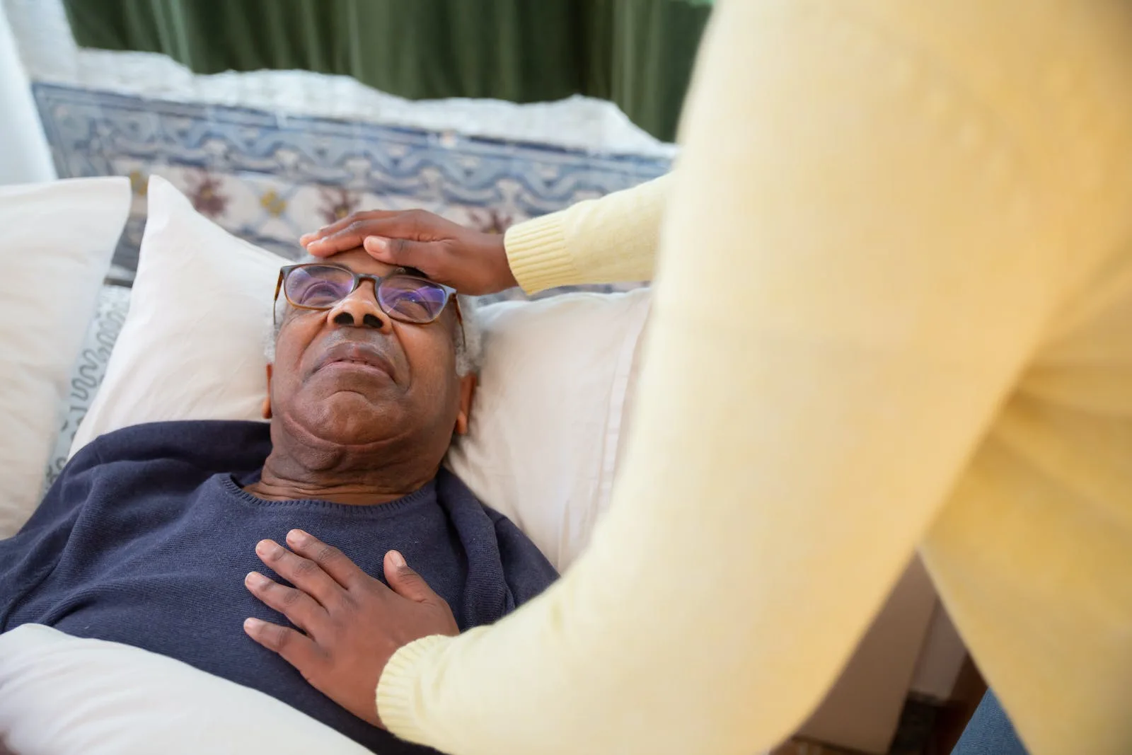 A Man in Blue Sweater Lying on the Bed - elderly 3 key benefits of owning an air puriifer